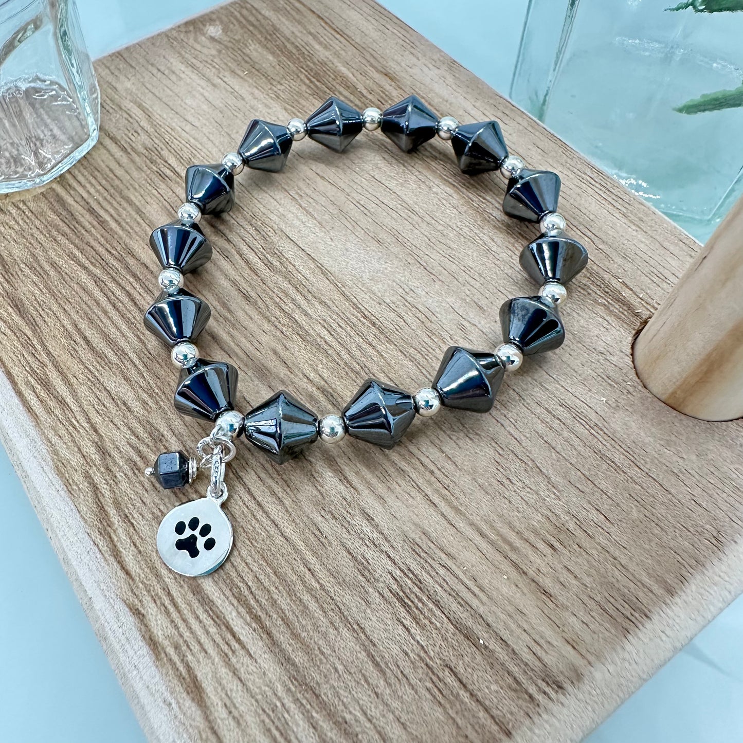 Hematite stretch bracelet with sterling silver paw print charm for pet lovers