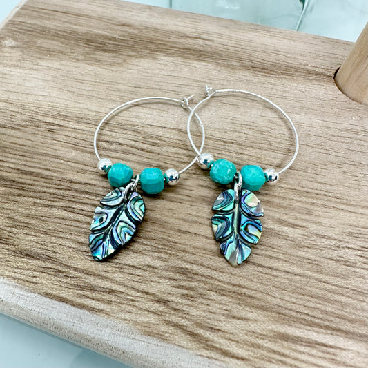 Sterling silver hoop earrings with carved abalone shell leaf charms and turquoise gemstone beads, handmade UK jewellery