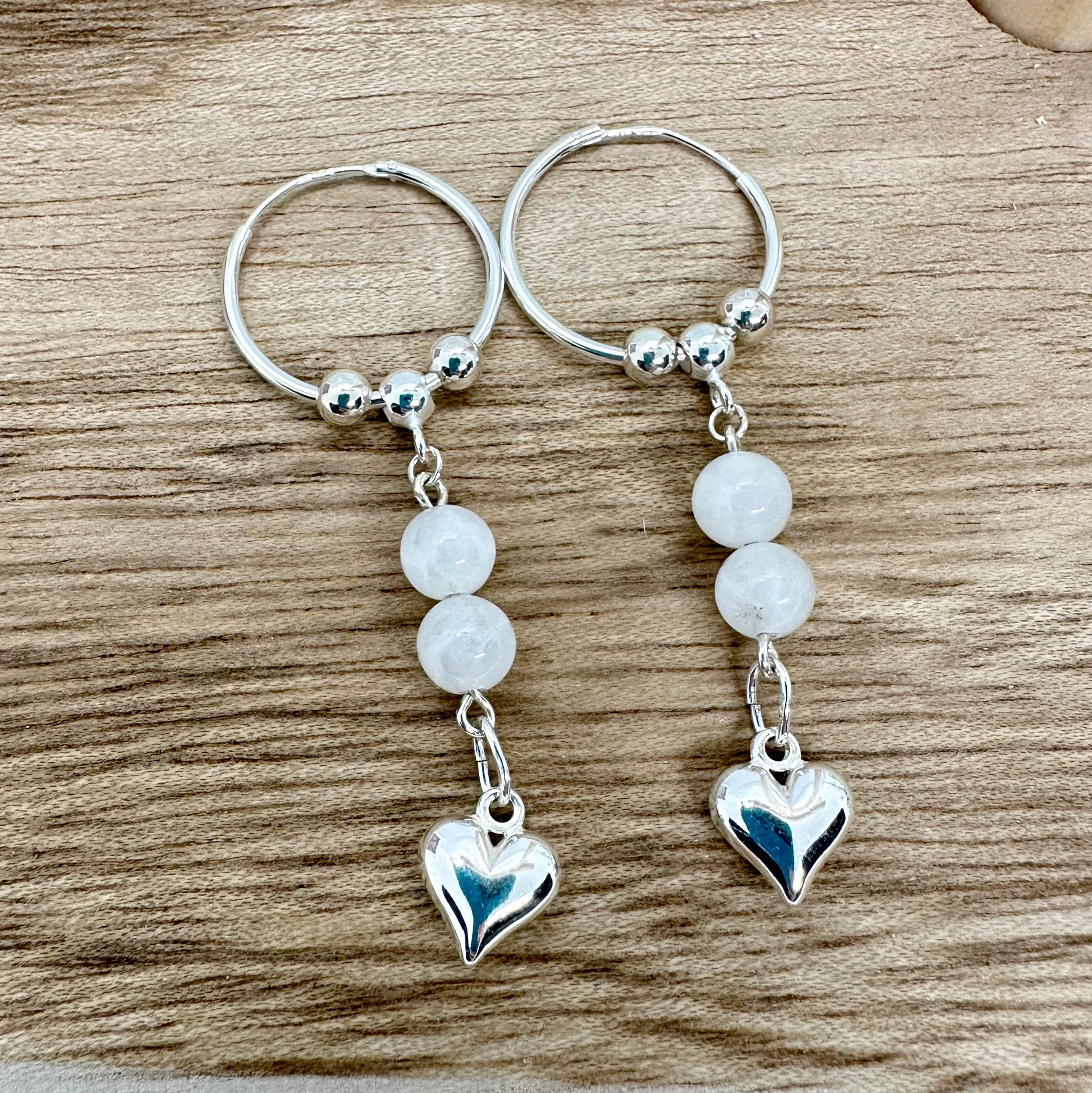 Sterling silver sleeper hoop earrings with moonstone beads and silver heart charm, handmade UK jewellery