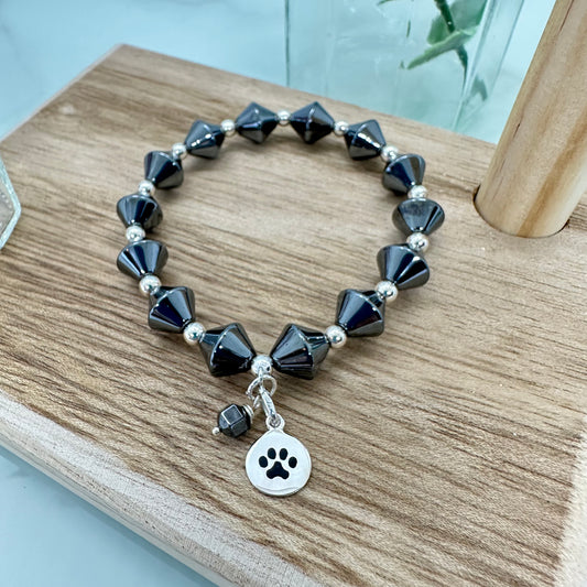 Hematite stretch bracelet with sterling silver paw print charm for pet lovers