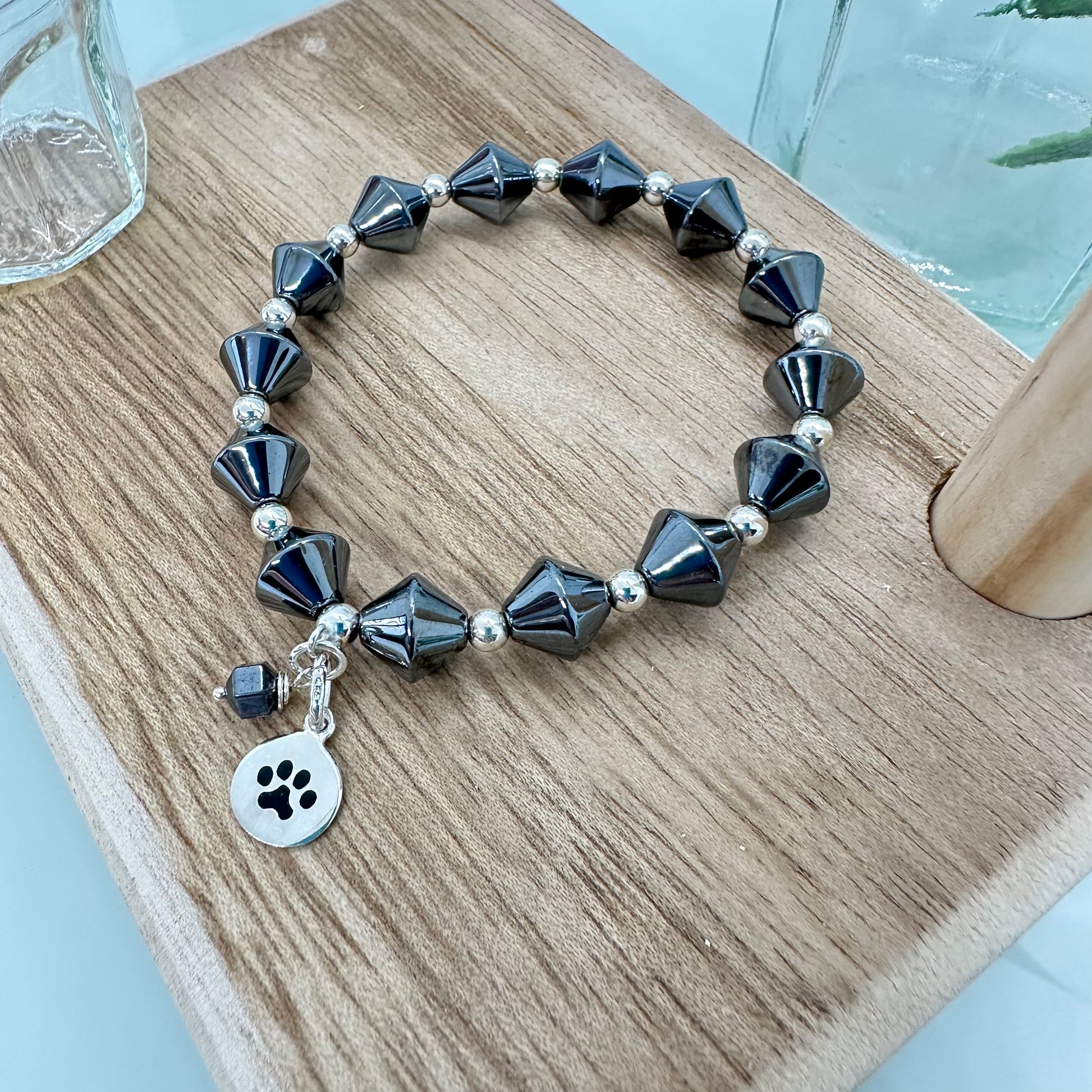 Hematite stretch bracelet with sterling silver paw print charm for pet lovers