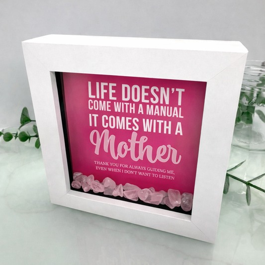 Handmade Mother’s Day or birthday gift shadow box frame with Life Doesn’t Come With a Manual quote and rose quartz crystal chips in white frame