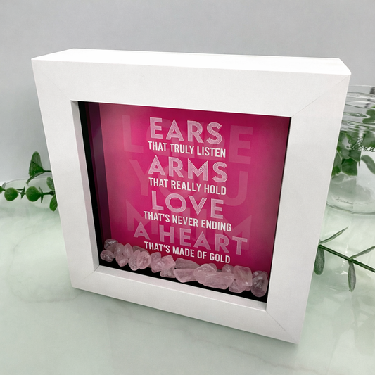 White framed decorative piece with pink interior and text, on a light gray surface.
Mothers day or birthday gift with rose quartz crystals.